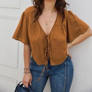 brown/orange shirt that is meant to be tied